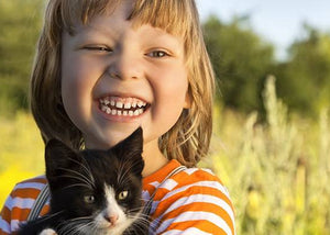 kitten with child in backyard